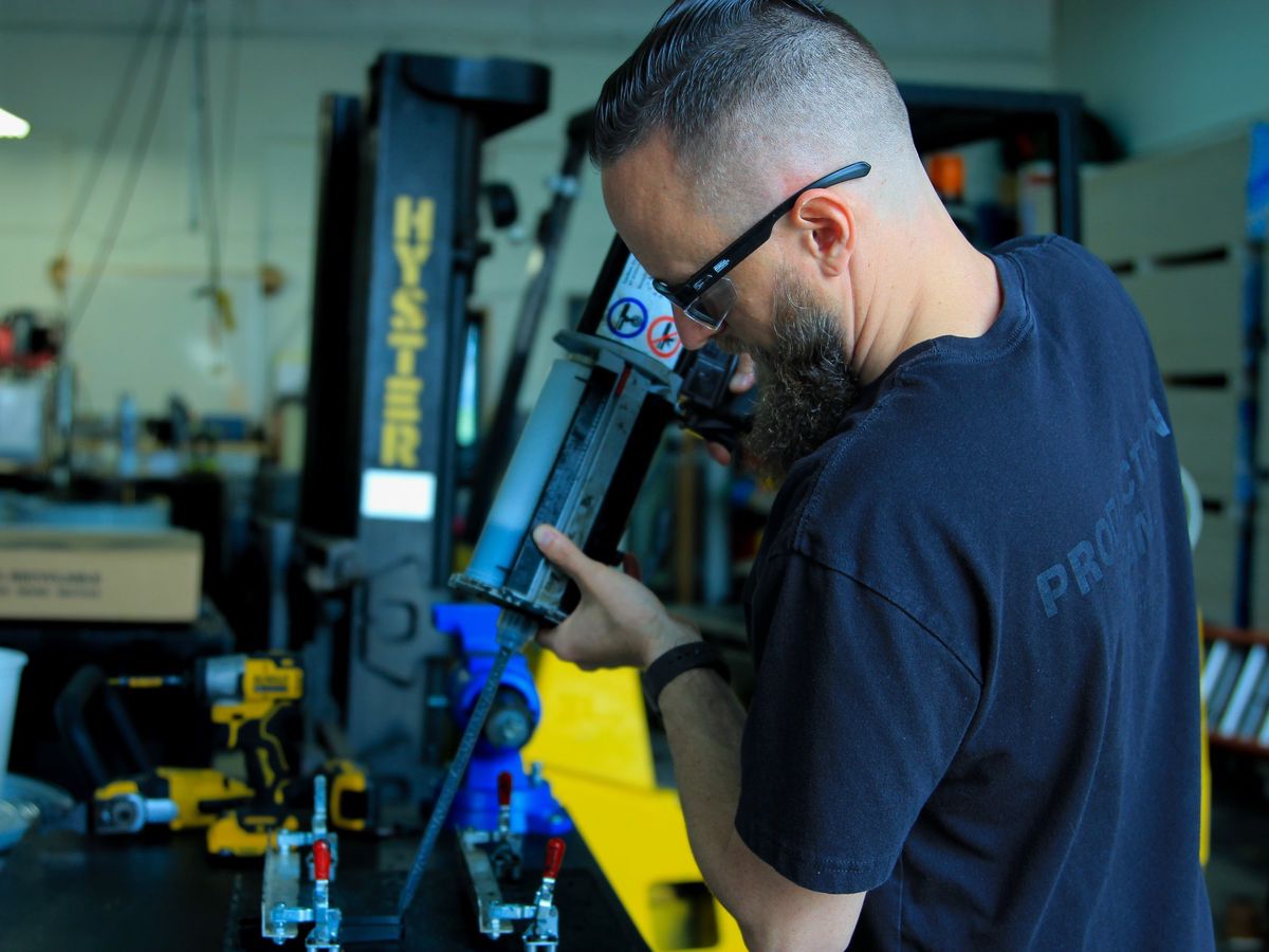 Titan Works operator dispensing polyurethane at the casting bench