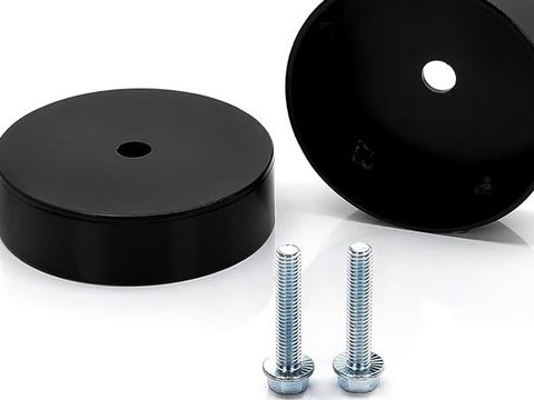Two black cast polyurethane spacer discs with mounting hardware